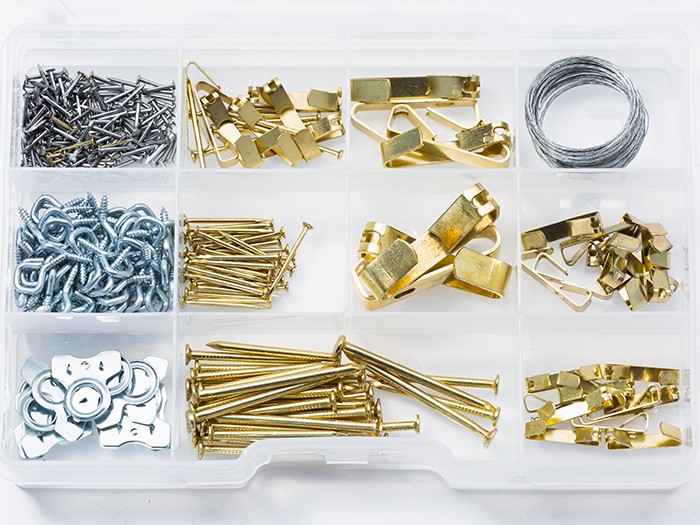Organized picture hanging hardware kit with nails, screws, hooks, and wire.