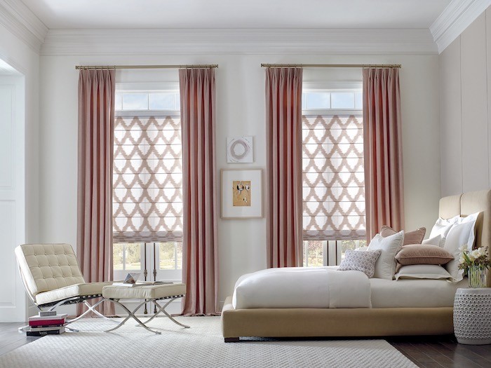 Bedroom with roller shades and long curtains